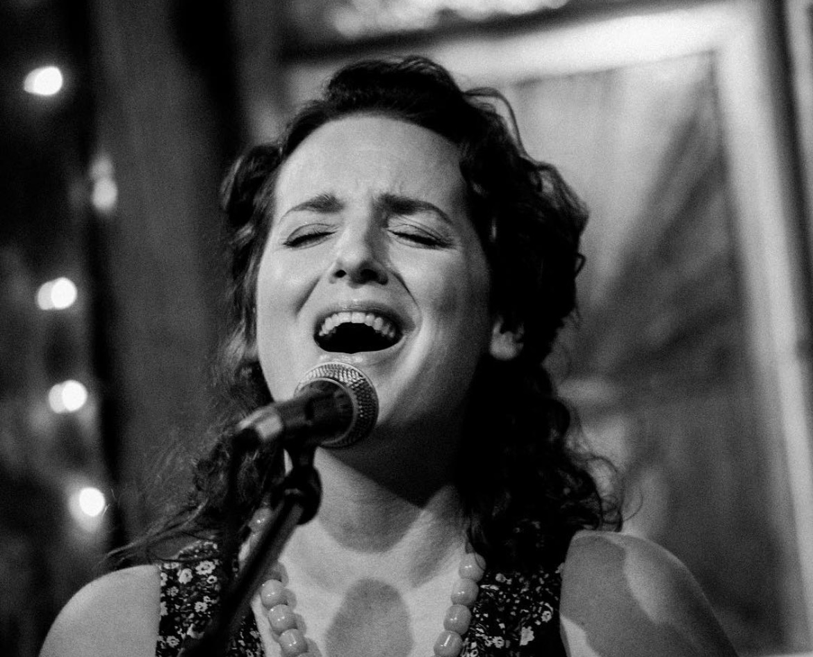 Black and white image, woman singing