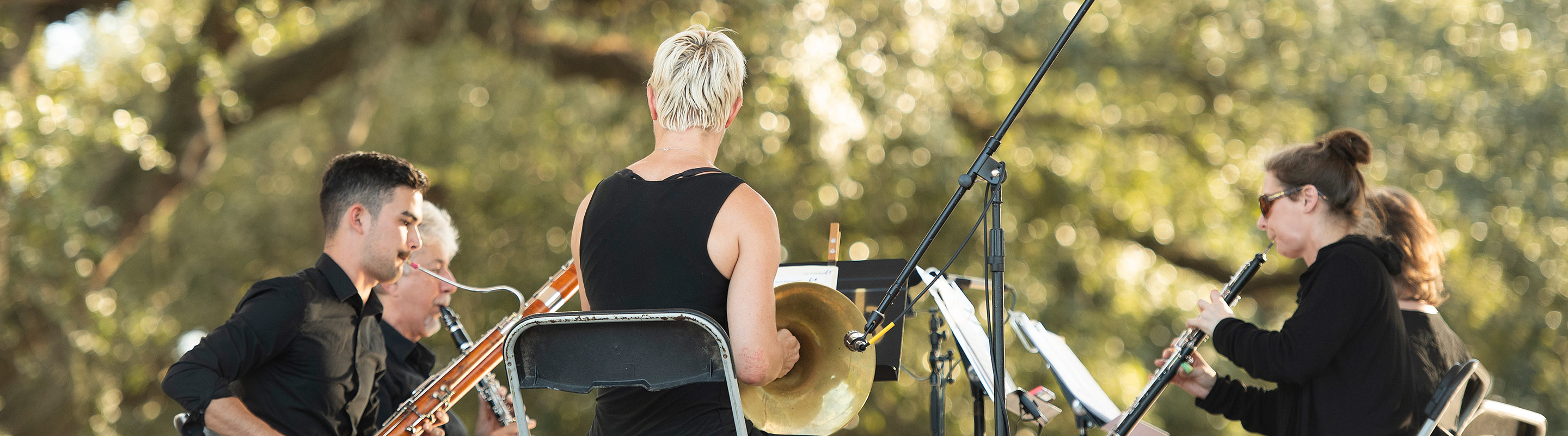 Masters students performing in a park