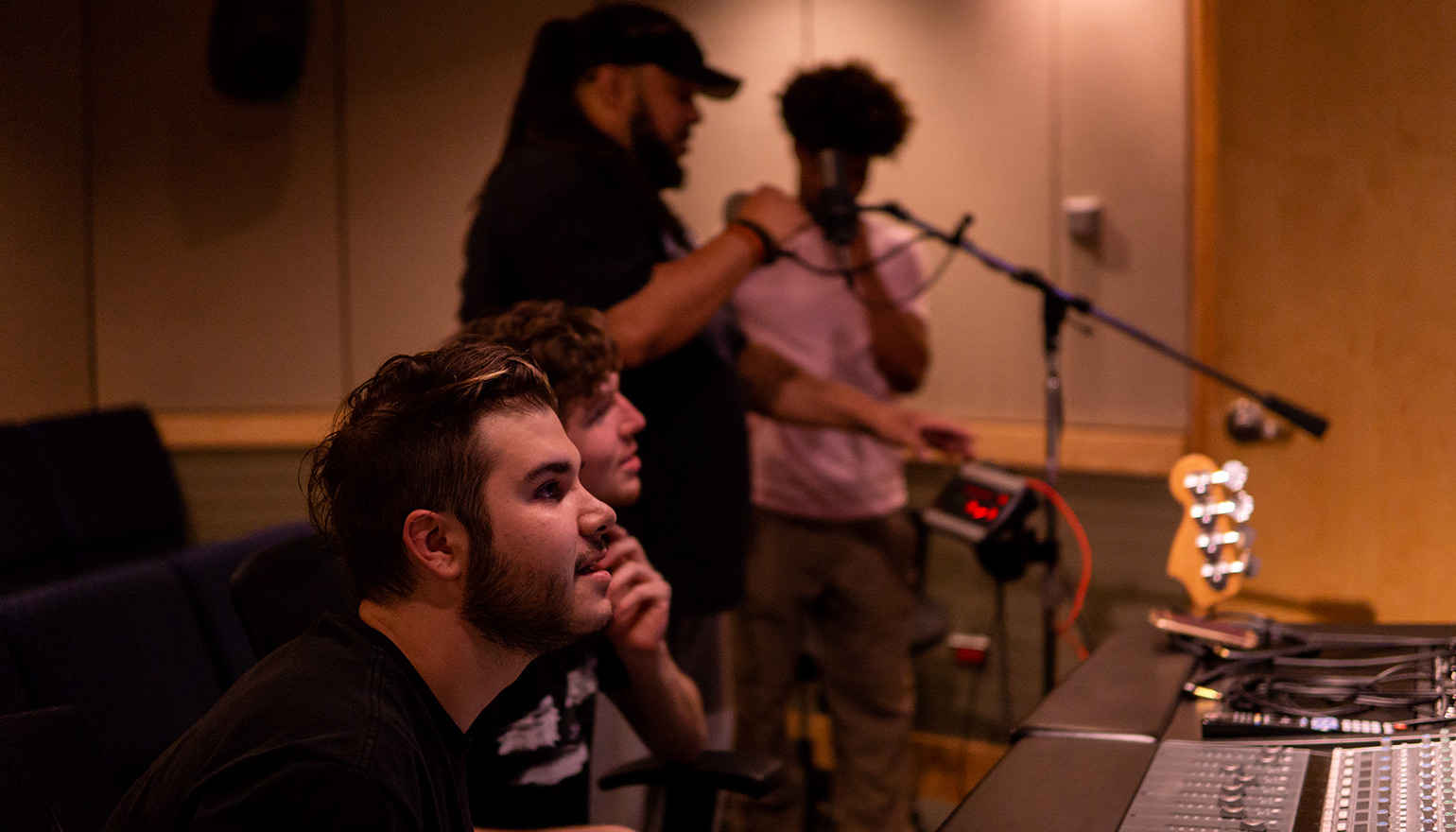 students with professor utilizing equipment