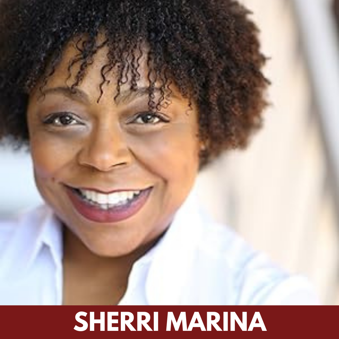 A Black woman with short, curly hair smiles widely.