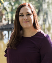 woman, long brown hair, trees background